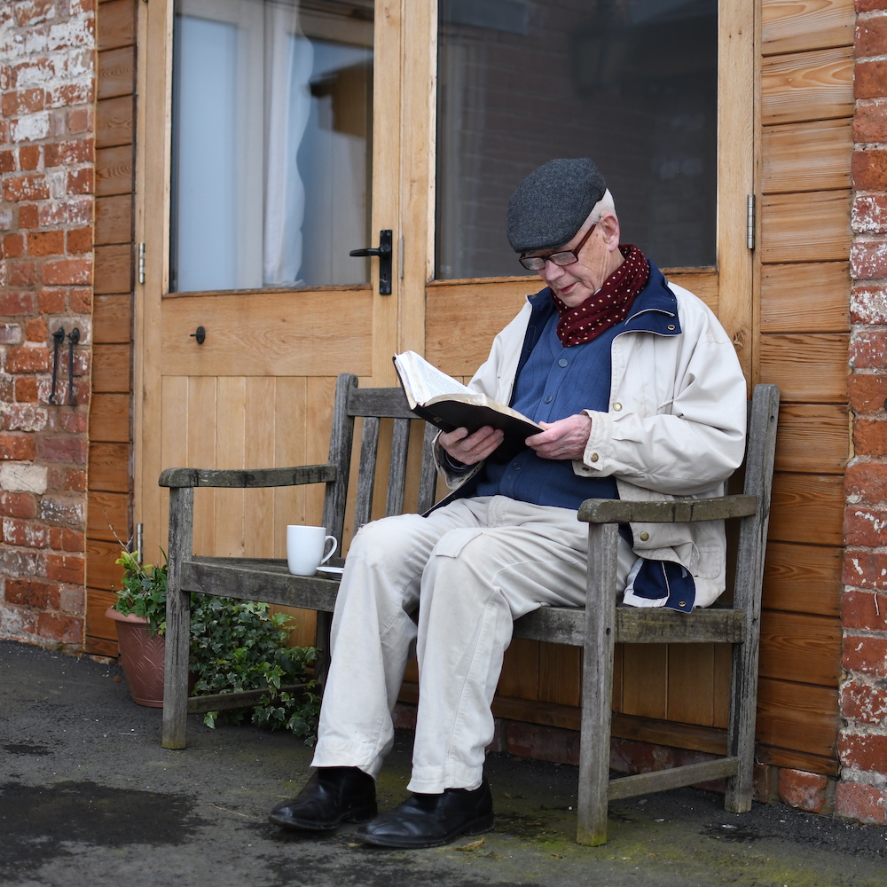 Elderly Plymouth Brethren member reading the Bible