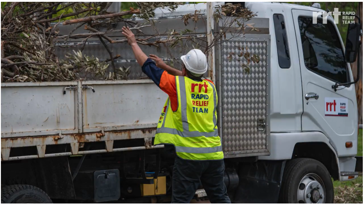 Man in RRT high vis putting branches into truck